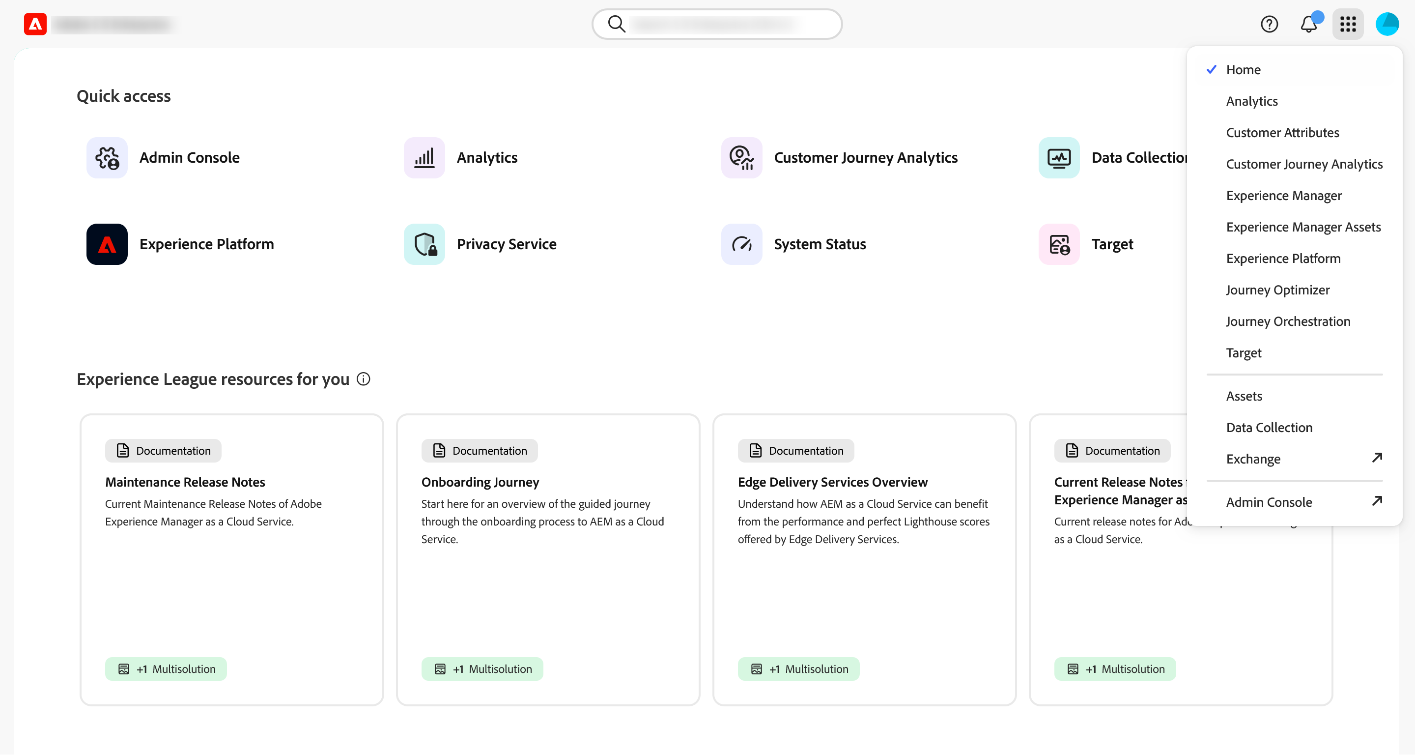 The Adobe Experience Cloud home page with the app switcher open. The header carries the Adobe logo beside an organisation name that has been blurred out, a search box in the centre, and help, notification and app switcher icons with a user avatar on the right. Below, a Quick access grid of eight tiles: Admin Console, Analytics, Customer Journey Analytics, Data Collection, Experience Platform, Privacy Service, System Status and Target. The app switcher panel open on the right lists Home with a tick, then Analytics, Customer Attributes, Customer Journey Analytics, Experience Manager, Experience Manager Assets, Experience Platform, Journey Optimizer, Journey Orchestration and Target, with Assets, Data Collection, Exchange and Admin Console below a divider.